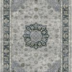 Traditional patterned rug with a border. Blues, silver on a grey background