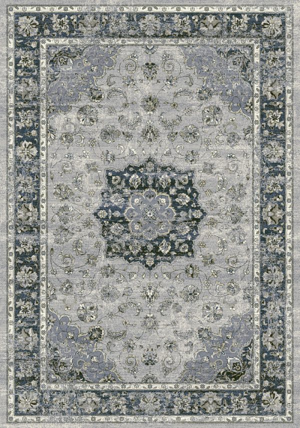 Traditional patterned rug with a border. Blues, silver on a grey background